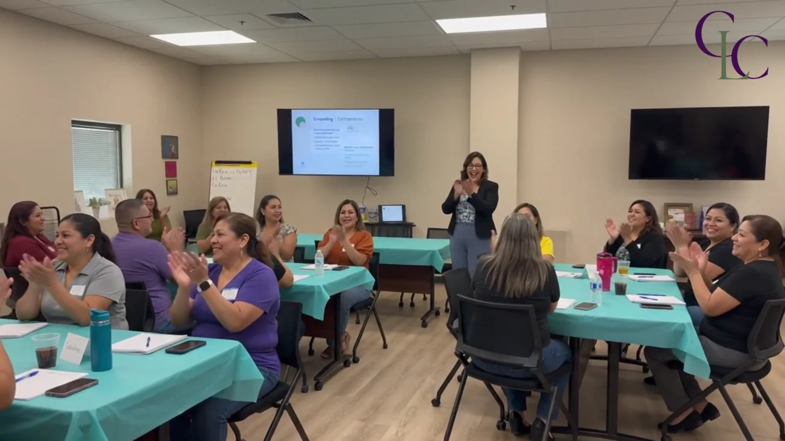 A group applauding during a Collective Love Coaching workshop